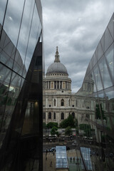 Fototapeta na wymiar St Pauls Cathedral with reflection in glass windows of One New Change shopping mall in London