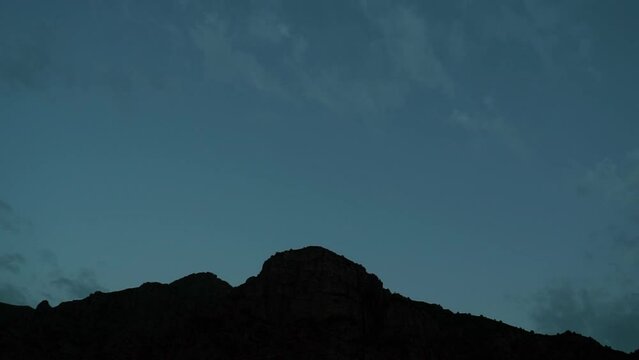 Timelapse of the mountains covered with tree with moving cloud and sunlight in the forest. from evening to night. High quality 4k footage
