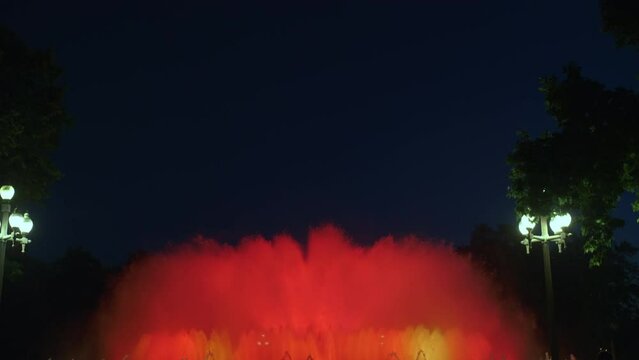 Magic singing magic fountains of Montjuic, people watch the performance that takes place several times a week