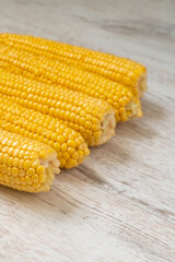 row of fresh yellow corn close-up with large and juicy grains