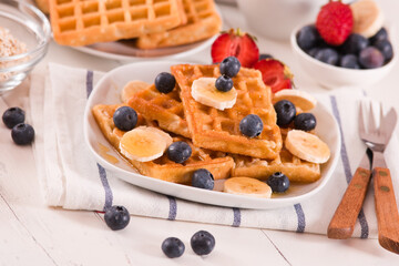 Waffles with blueberries, bananas and honey.