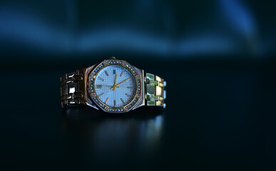 Luxury watches placed on a glittering glass floor	