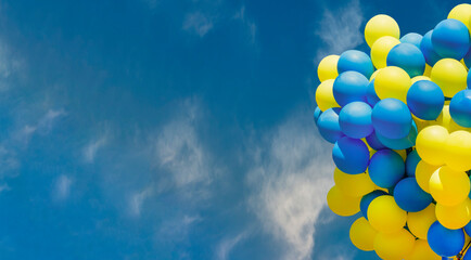 Yellow and blue balloons on the sky. Big bunch of balls. helium balloon background with place for text. Copy space banner. © Real_life