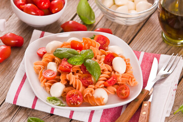 Fusilli pasta with cherry tomatoes and mozzarella cheese.