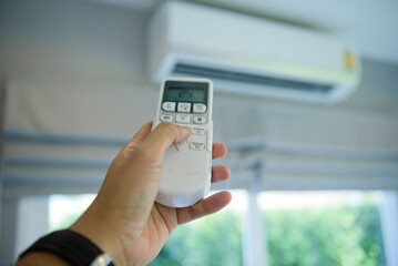 remote control air condition on hand, save power concept
