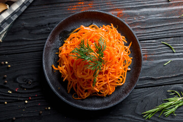 Korean carrot on black plate top view