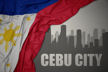 abstract silhouette of the city with text Cebu City near waving national flag of philippines on a gray background.3D illustration