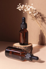 Glass dropper bottle with cosmetic serum on wooden stump podium. Hyaluronic acid oil with collagen and peptides skin care product. - obrazy, fototapety, plakaty
