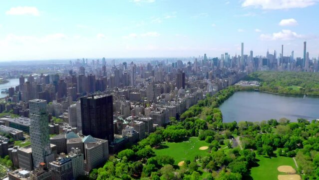 Aerial 4k video above green Central park in the middle of Manhattan, New York City during summer time. Beautiful New York city from above.