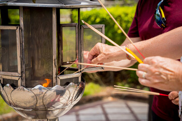 Ritual of burning incense sticks at the big Thai temple
