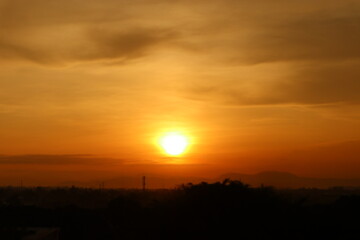 Beautiful evening sunset morning sunrise scenery from rooftop  with amazing clouds and red sky in the background 
