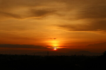 Beautiful evening sunset morning sunrise scenery from rooftop  with amazing clouds and red sky in the background 