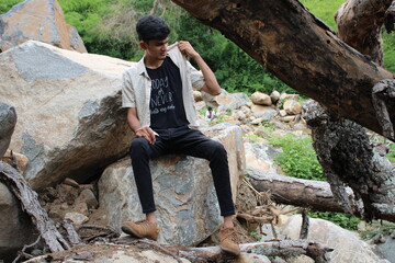 man sitting on a rock