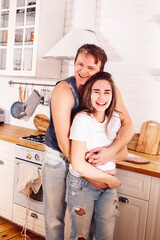 young caucasian couple together having fun on kitchen, woman pregnant, lifestyle people concept