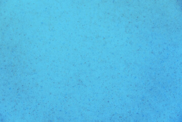bright blue background mottled with grey sparkles