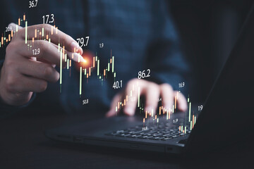 Businessman drawing virtual technical graph and chart for analysis stock market, technology...