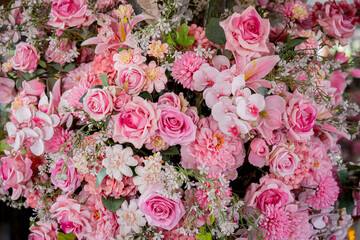 Big bouquet of flowers in a vase on a gray wall background