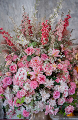 Big bouquet of flowers in a vase on a gray wall background