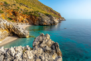 Paradise empty beach with no people and turquoise sea named "Cala Capreria" at the natural reserve “Riserva dello Zingaro”, Scopello, Sicily, Mediterranean Sea, Italy.