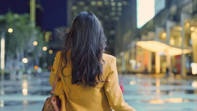 Urban modern lifestyle fashion portrait of asian young female stylish casual Asia woman walking 
 with confident back view on the urban downtown street, wearing cute trendy outfit after raining