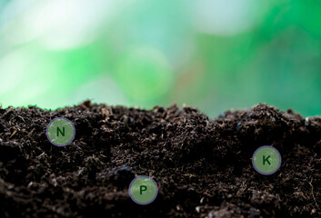 rich soil and nature background with all the elements needed to grow, while digital icons represent elements.nutrients needed by plants are nitrogen, phosphorus, potassium and others.