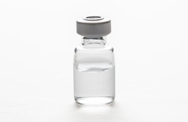 Medical vial for injection isolated cutout on white background. Overhead view, copy space.