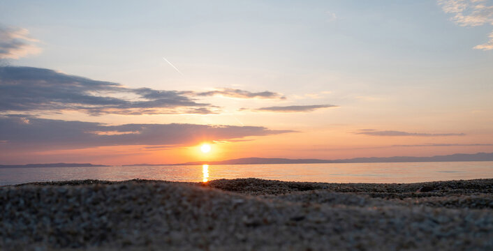 Sandy beach empty at sunset. Greece. Ripple on the wet sand, colorful cloudy sky. Greece, Chalcidice