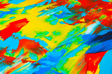 Fototapeta na wymiar Closeup view of artist's palette with mixed bright paints as background
