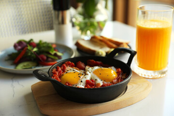 Tasty Shakshouka served on white table. Traditional Arabic dish