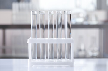 Test tubes with transparent liquid on table in laboratory
