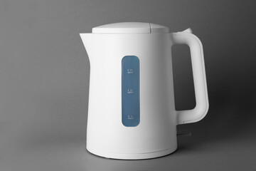New modern electric kettle on grey background