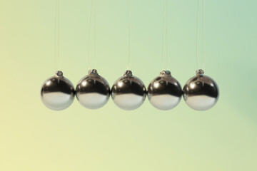 Newton's cradle on color background. Physics law of energy conservation