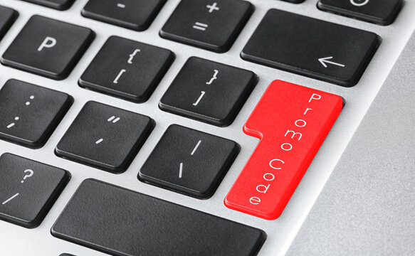 Red button with phrase Promo Code on computer keyboard, closeup view