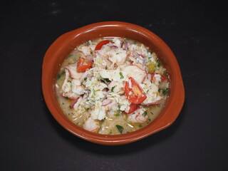 Seafood Ceviche served in a dish isolated on dark background top view