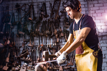 Authentic handsome indian man in leathern apron hammer industry small business