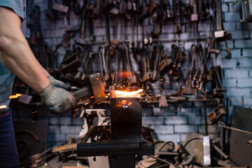 italian brunette man blacksmith working in the workshop