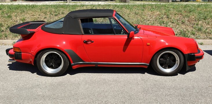 Azzida, Italy. July 2, 2022. Red Porsche 911 Carrera 3.2 of the Eighties , during a vintage car  gathering .