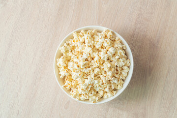 popcorn on the wooden table. flat lay of popcorn in bowl. top view