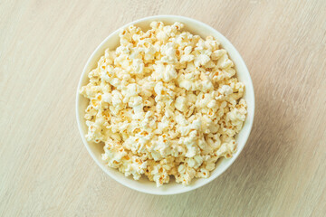 popcorn on the wooden table. flat lay of popcorn in bowl. top view. copy space for text