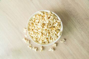 popcorn on the wooden table. flat lay of popcorn in bowl. top view. copy space for text