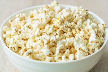Selective focus. close up of popcorn in bowl on the wooden table.