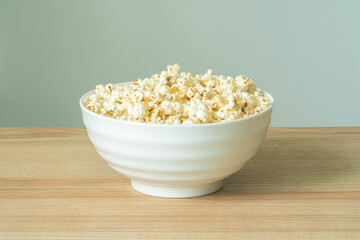 close up of popcorn in bowl on the wooden table.