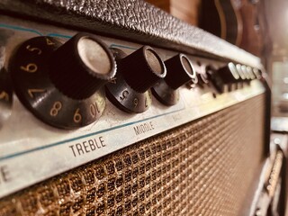 Close up of the black gain knob a vintage electric guitar clean amplifier .music store and business. wallpaper or background with warm vintage filter style. master volume knob.	
 - obrazy, fototapety, plakaty