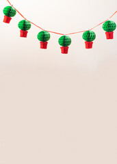 Manjerico paper garland against the beige background with copy space. Traditional Summer festival...