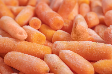 Frozen healthy baby carrots for eating. close up