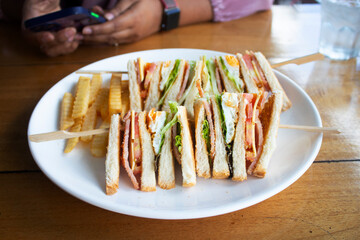 Isolated shot of a club sandwich and french fries - perfect for a food blog or menu usage