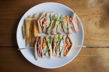 Isolated shot of a club sandwich and french fries - perfect for a food blog or menu usage
