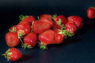 Red berries strawberry on black background.