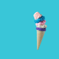 Ice cream cone on a blue background. Top view with copy space.