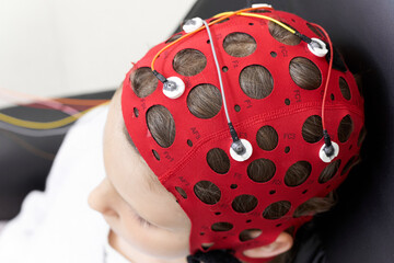 Girl wearing headgear during a session of biofeedback therapy